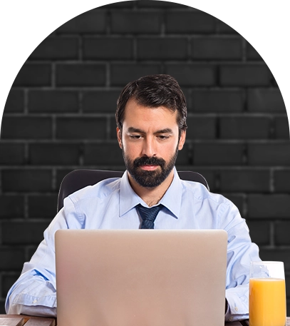 A man writing a restaurant report on his laptop